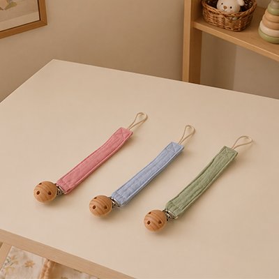 Attache tetine mignonne avec fleur décorative fixée sur la tenue de bébé